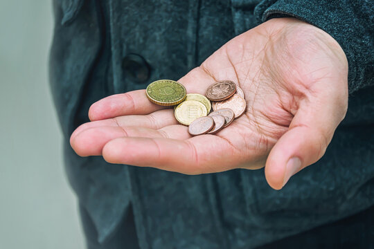 A few coins in men's hand, selective focus.	