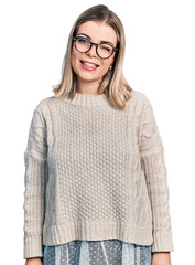 Young blonde woman wearing glasses winking looking at the camera with sexy expression, cheerful and...