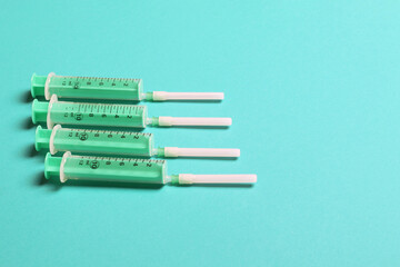 Top view of different syringes for injection on colorful background. Medical equipment concept with copy space