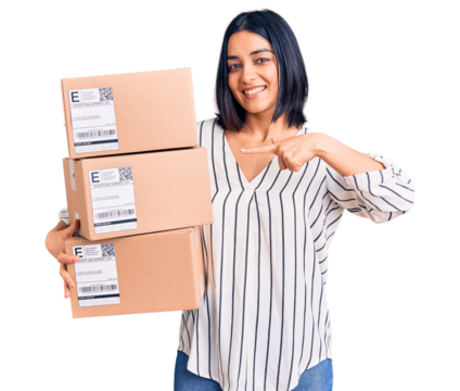 Young beautiful latin woman holding delivery package smiling happy pointing with hand and finger