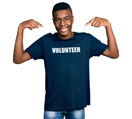 Young african american man wearing volunteer t shirt looking confident with smile on face, pointing oneself with fingers proud and happy.