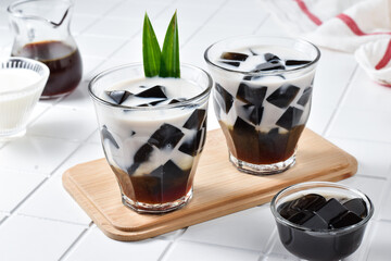 Summer drink Es Cincau Hitam, made from black grass jelly with coconut milk and palm sugar. Has a...