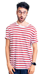 Obraz premium Young hispanic man wearing casual clothes afraid and shocked with surprise and amazed expression, fear and excited face.