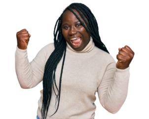 Young black woman with braids wearing casual winter sweater screaming proud, celebrating victory and success very excited with raised arms