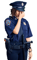 Young beautiful girl wearing police uniform tired rubbing nose and eyes feeling fatigue and headache. stress and frustration concept.