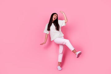 Full body portrait of overjoyed girl dancing enjoy free time partying isolated on pink color background