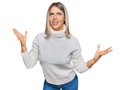 Beautiful blonde woman wearing casual turtleneck sweater crazy and mad shouting and yelling with aggressive expression and arms raised. frustration concept.