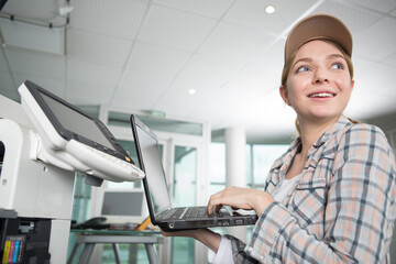 happy woman technician trying to get the printer issue
