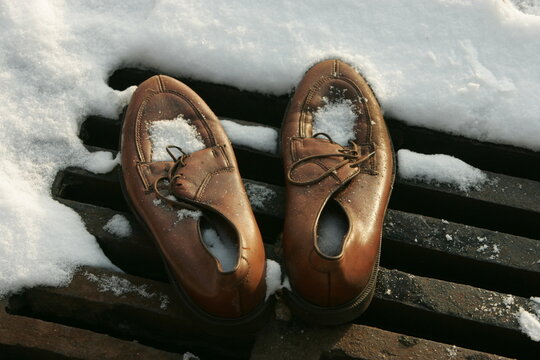 Pair Of Homeless Persons Shoes In The Snow 