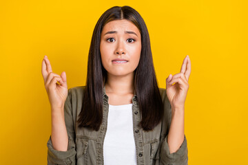 Portrait photo of young nervous grimace chinese woman wear khaki shirt bite lips nervous wish best...