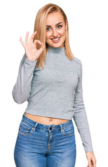 Beautiful caucasian woman wearing casual clothes smiling positive doing ok sign with hand and fingers. successful expression.