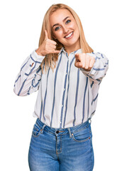 Beautiful caucasian woman wearing casual clothes smiling doing talking on the telephone gesture and...