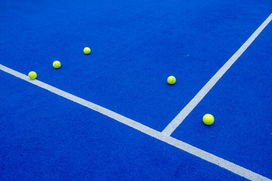padel tennis balls on a blue court, racket sports concept