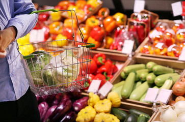 Fototapeta na wymiar buying vegetables(cucumbers, tomatoes, onions, peppers, eggplant, zucchini) at the market