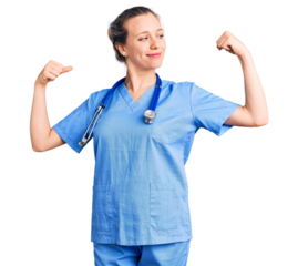 Young beautiful blonde woman wearing doctor uniform and stethoscope showing arms muscles smiling proud. fitness concept.