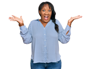Hispanic middle age woman wearing casual clothes celebrating victory with happy smile and winner expression with raised hands