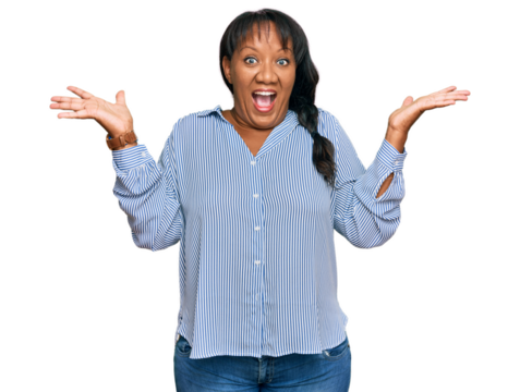 Hispanic middle age woman wearing casual clothes celebrating victory with happy smile and winner expression with raised hands