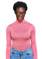 Young african american girl wearing casual clothes and glasses winking looking at the camera with...