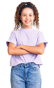 Beautiful kid girl with curly hair wearing casual clothes happy face smiling with crossed arms looking at the camera. positive person.