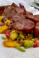 Pork Sausage cut in slides over a bed of Vegetable 