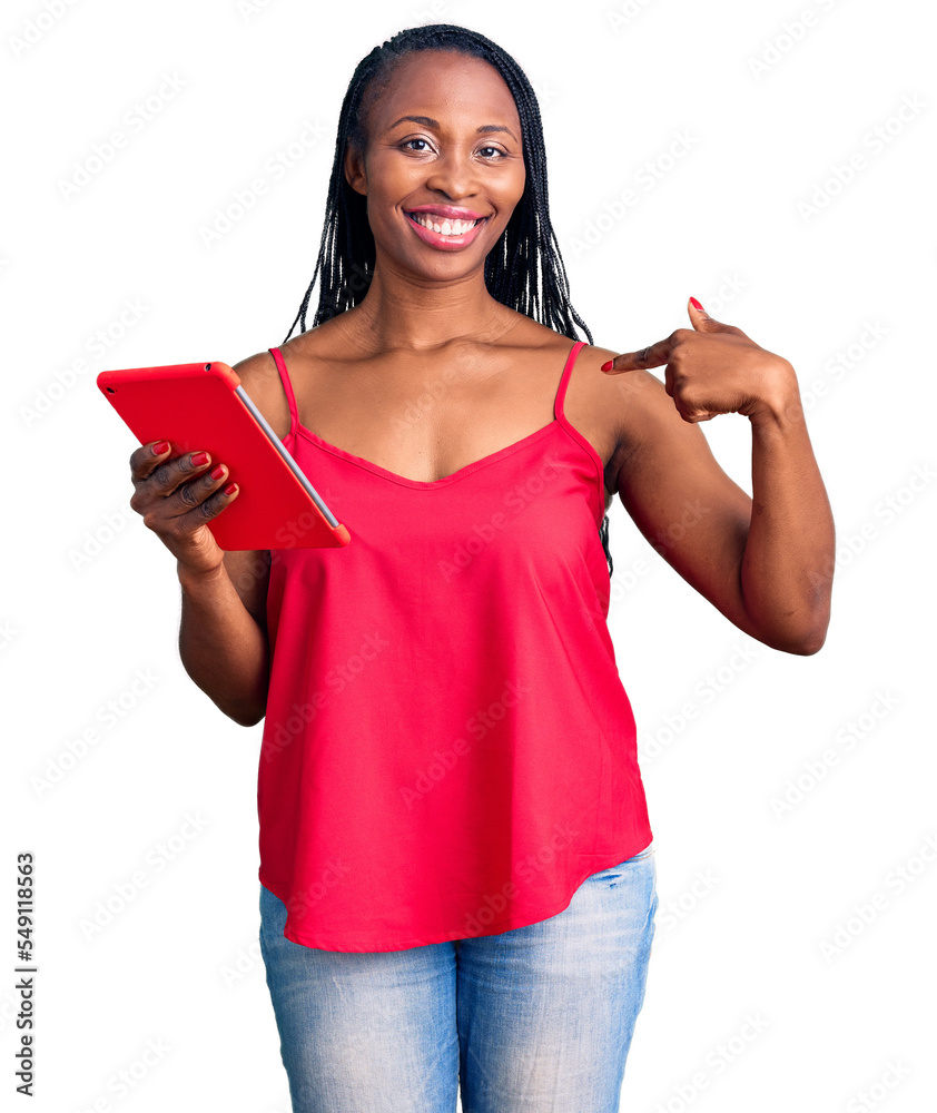 Sticker Young african american woman holding touchpad pointing finger to one self smiling happy and proud