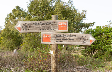 Via Algarviana (GR13) wooden signpost pointing the way to Barranco do Velho and Salir, municipality of Loulé, district of Faro, Algarve, Portugal