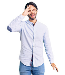 Handsome hispanic man wearing business shirt and glasses doing ok gesture with hand smiling, eye looking through fingers with happy face.