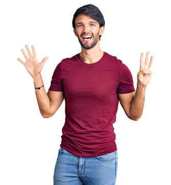 Handsome hispanic man wearing casual clothes showing and pointing up with fingers number eight while smiling confident and happy.