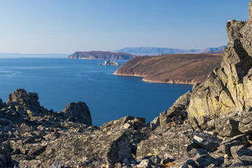 View of the rocks, the sea and the coast. Autumn landscape. Nature of Siberia and the Russian Far East. Travel, tourism and hiking in the Magadan region. Stone Crown Mountain. Sea of Okhotsk, Russia.