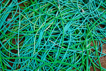 Outer casings of pvc electrical cables, abandoned and discarded, ready for recycling.