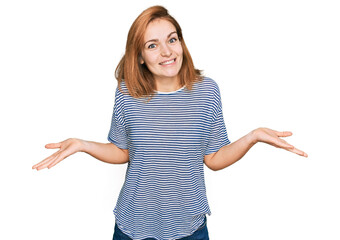 Young caucasian woman wearing casual clothes clueless and confused expression with arms and hands...