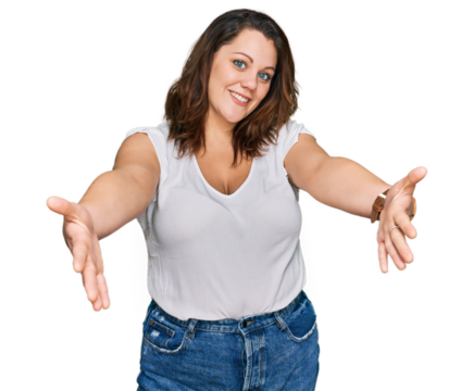 Young plus size woman wearing casual white t shirt looking at the camera smiling with open arms for hug. cheerful expression embracing happiness.