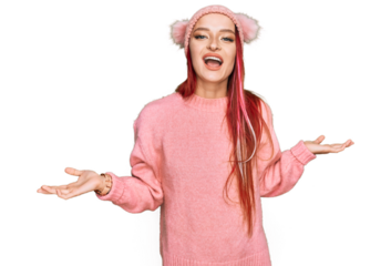 Young caucasian woman wearing casual clothes and wool cap smiling cheerful with open arms as friendly welcome, positive and confident greetings