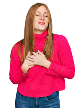 Young irish woman wearing casual clothes smiling with hands on chest with closed eyes and grateful gesture on face. health concept.