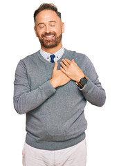 Handsome middle age man wearing business clothes smiling with hands on chest with closed eyes and grateful gesture on face. health concept.
