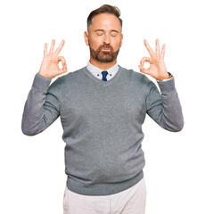 Handsome middle age man wearing business clothes relaxed and smiling with eyes closed doing meditation gesture with fingers. yoga concept.