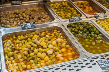 Variety of olives on the counter of a market