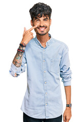Young hispanic man wearing casual clothes pointing with hand finger to face and nose, smiling cheerful. beauty concept