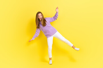 Fototapeta na wymiar Full length photo of concentrated focused lady wear comfort trendy clothes move look empty space isolated on yellow color background