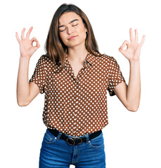 Young caucasian girl wearing casual clothes relax and smiling with eyes closed doing meditation gesture with fingers. yoga concept.