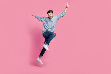 Full body size photo of young handsome attractive pretty funny grimace man student hands up celebrate ending day worker isolated on pink color background