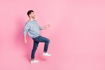 Side profile photo full body length of young attractive handsome guy positive walk empty space career success isolated on pink color background