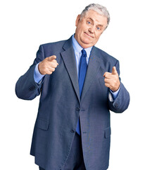 Senior grey-haired man wearing business jacket pointing fingers to camera with happy and funny face. good energy and vibes.
