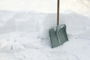 Textured surface, Shovel for snow next to snowdrift, snow winter, close-up