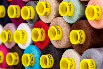 set of multi-colored spools of thread for sewing