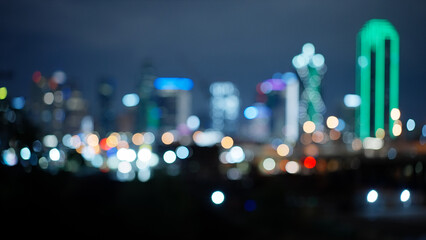 Blurred background of Dallas Texas skyline by night - travel photography