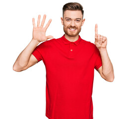 Fototapeta premium Young redhead man wearing casual clothes showing and pointing up with fingers number six while smiling confident and happy.