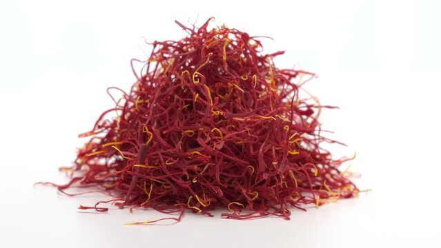 Heap of Moroccan saffron rotating on white background. 