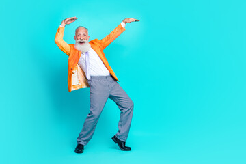Full length photo of cheerful eccentric retired man wear stylish orange clothes enjoy concert empty...
