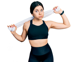 Young brunette woman with blue eyes wearing sportswear and towel puffing cheeks with funny face. mouth inflated with air, catching air.